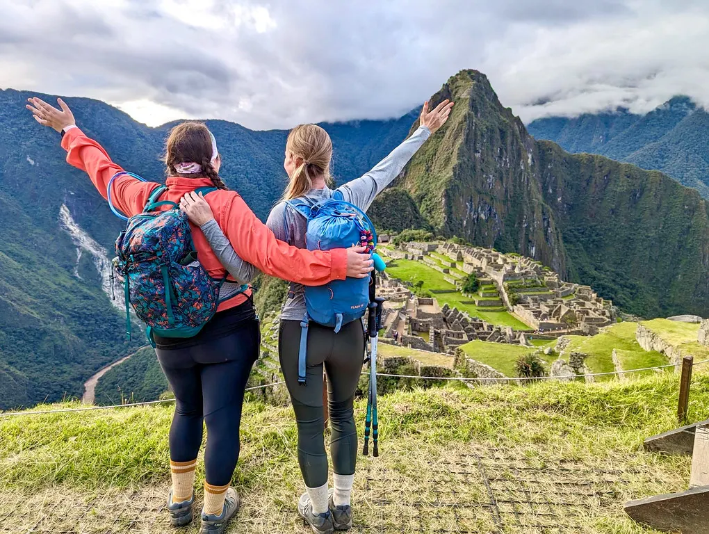 Hikers overlooking Machu Picchu after completing a scenic trek in the Andes.