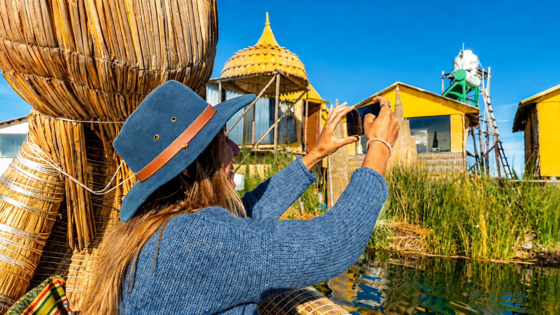 Traveler taking photos during a Uros Floating Islands tour