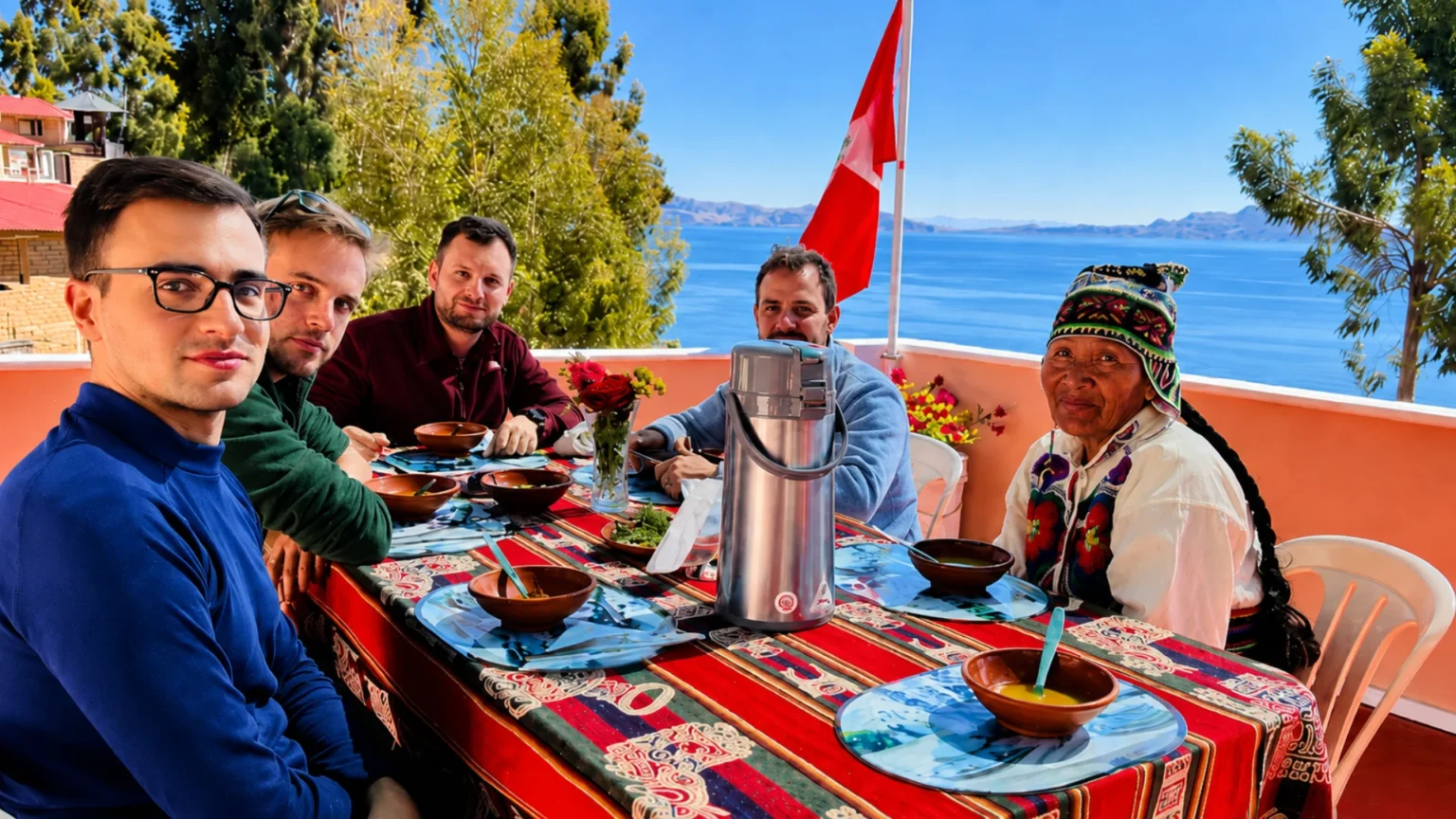 Travelers sharing a traditional meal during an Amantani homestay