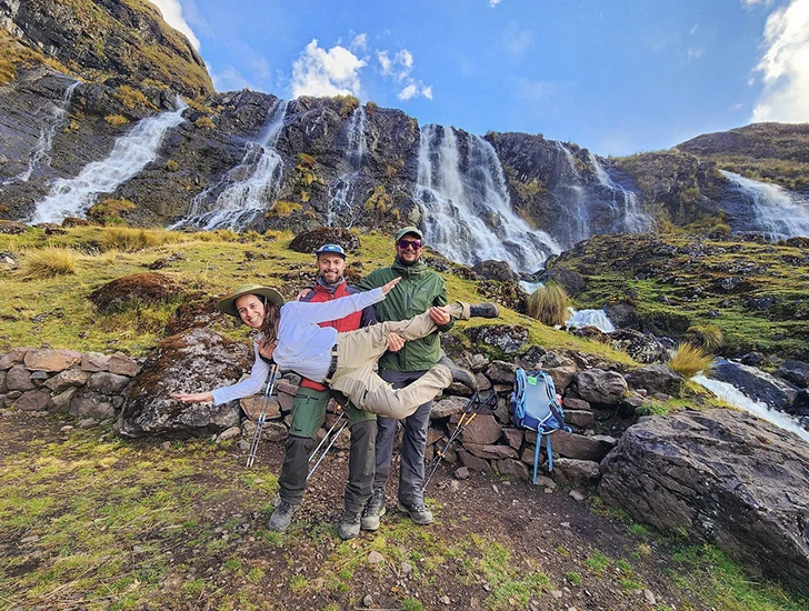 Travelers-under-quiswarani-waterfalls-lares-trek-4-days-3-nights-cusco-peru