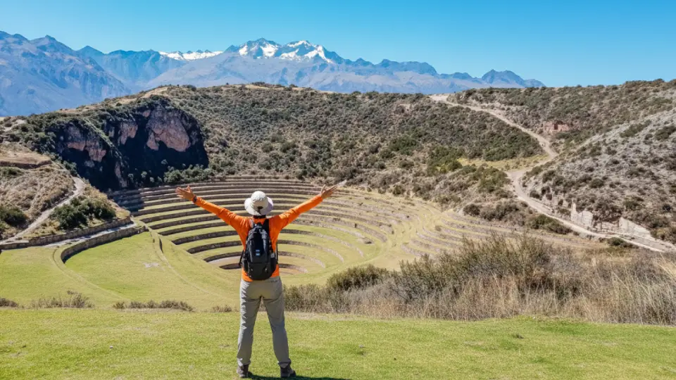 Happy tourist visiting the Inca laboratory of Moray