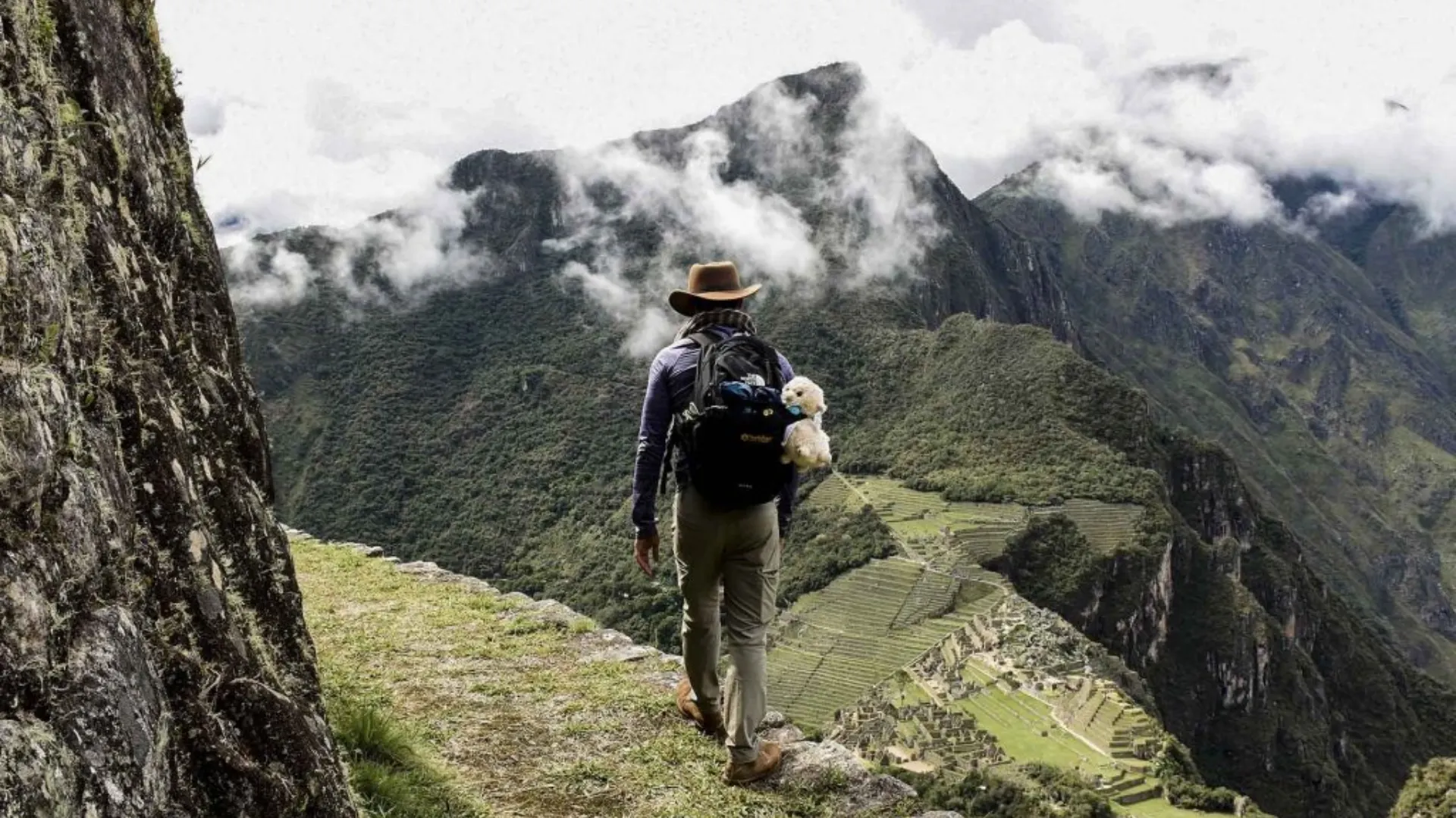inca trail hiker overlooking machu picchu