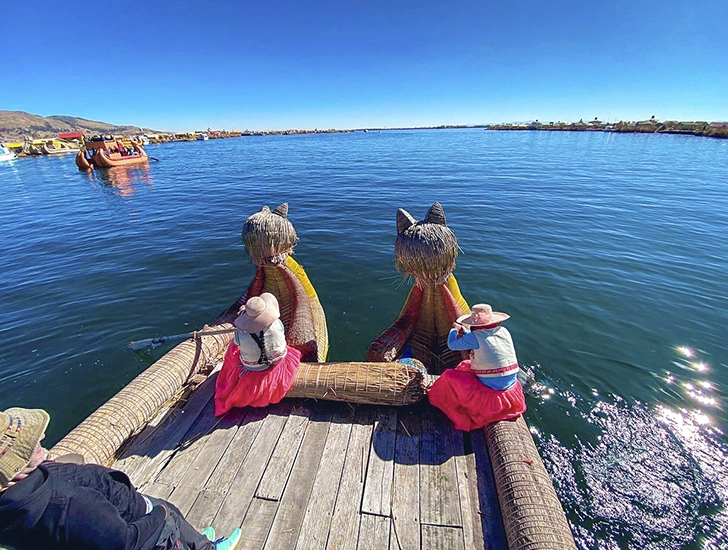 Scenic view of Lake Titicaca with its blue waters and local communities, one of Peru’s most iconic destinations.