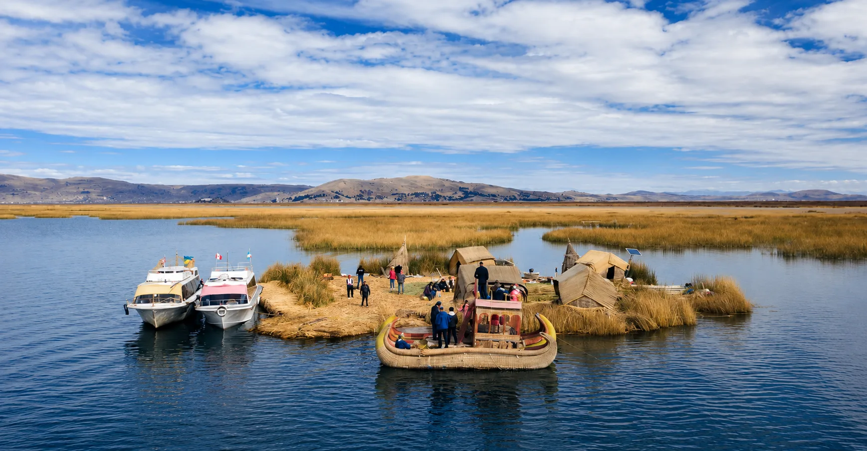 Tour boat arriving at the Uros floating islands on Lake Titicaca