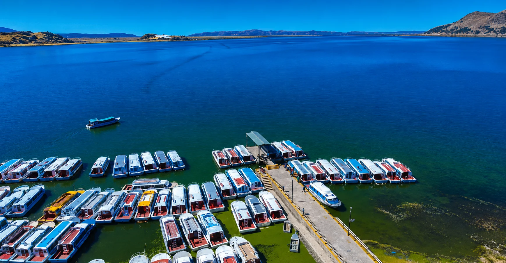 Tour boats at Puno port for Lake Titicaca island excursions