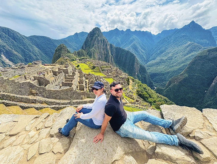 Travelers exploring Machu Picchu on Day 3 of the Cusco 4 Days 3 Nights tour, enjoying a guided visit to the Inca citadel.