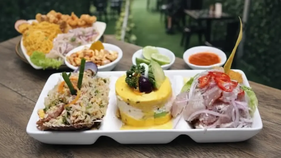Tasting of a mixed ceviche sampler served with potato causa