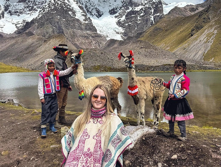 tourist-with-local-children-and-llamas-ausangate-cusco-peru